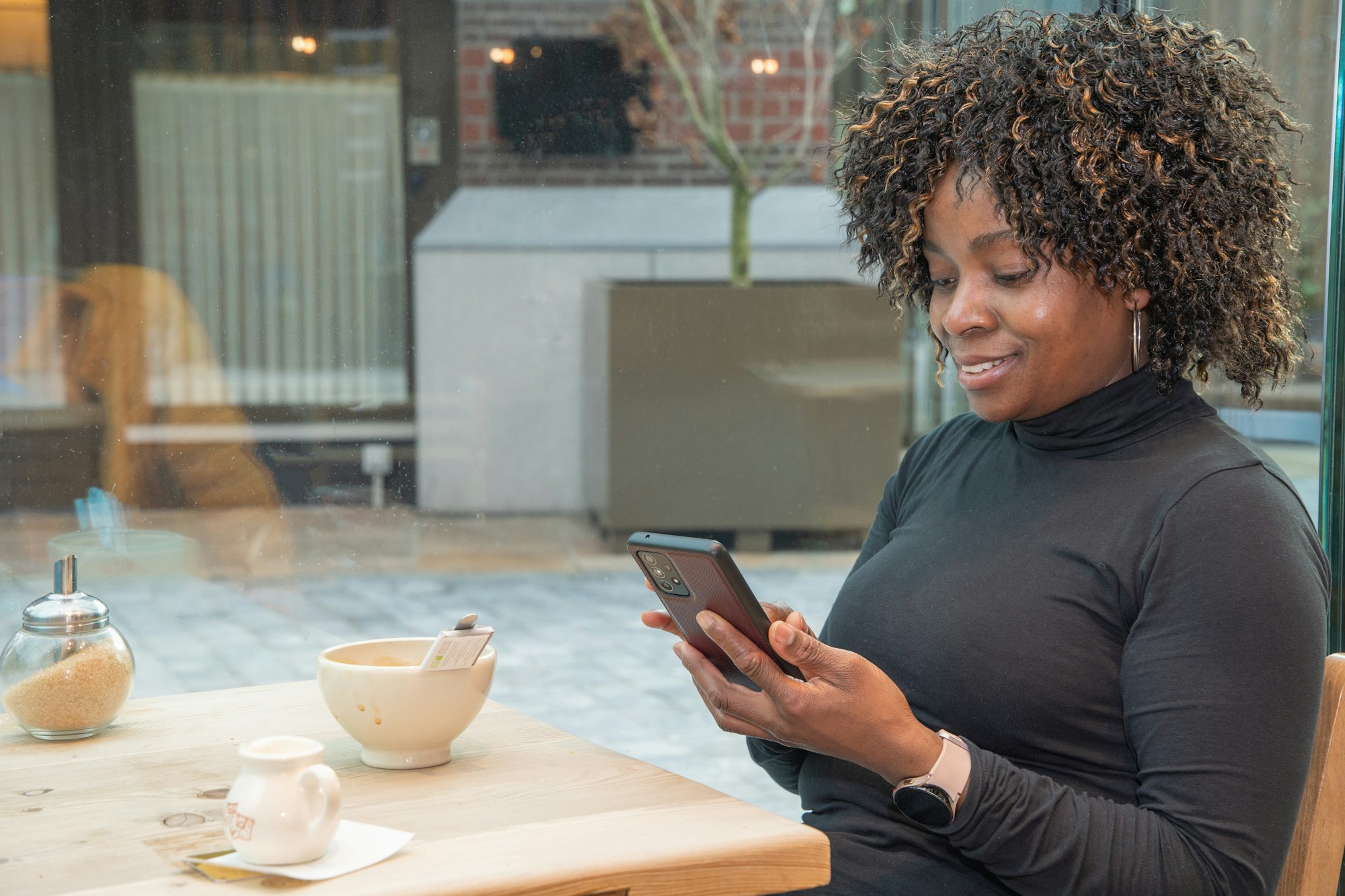 African american woman pays for the order using the application on the phone