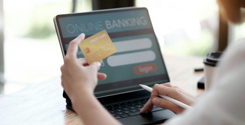 Online payment,woman's hands holding a credit card and using laptop computer for online shopping